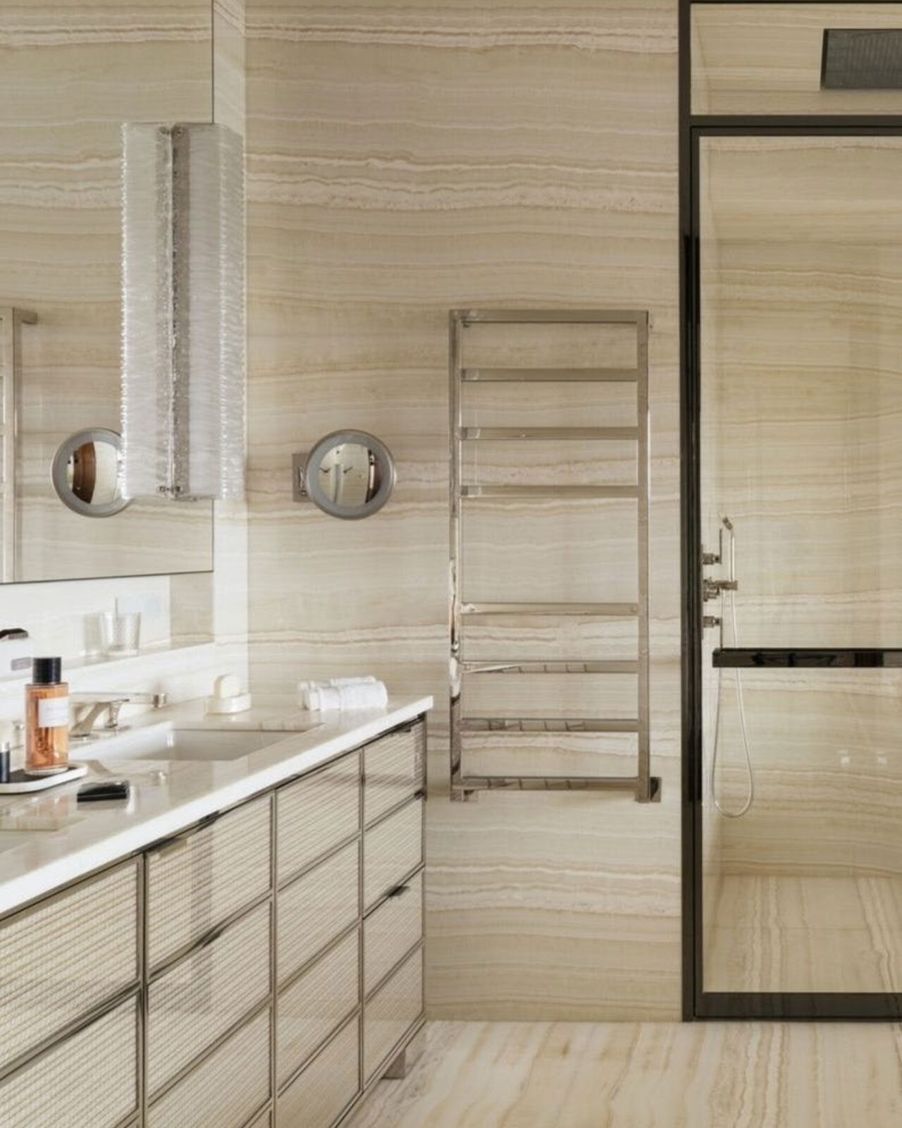 Travertine bathroom with a polished towel radiator and walk-in shower